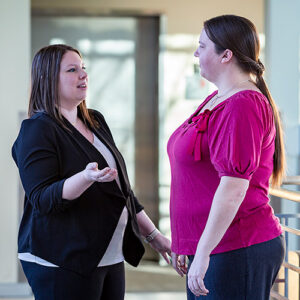 picture of Ashley talking to Melissa in casual conversation