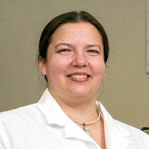 Melissa Budde headshot in lab coat